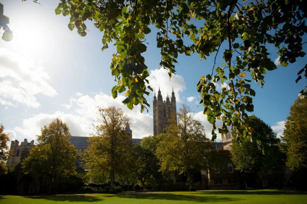 An image of The King's Summer School taken from a treeline, demonstrating the beauty of both its grounds and historical architecture