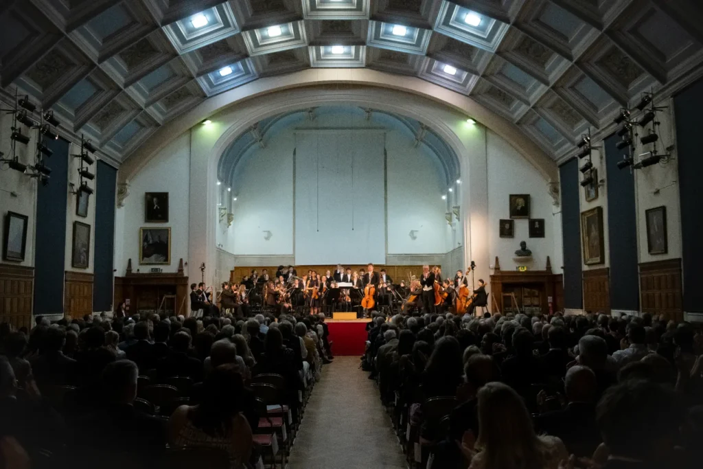 A group of music students at The King’s Summer School putting on an orchestral music performance in front of a crowd.
